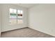 Bright bedroom with neutral carpet and a large window at 1615 Clover Crossing Dr # 2A, Greenfield, IN 46140