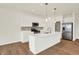 Modern kitchen with stainless appliances, white cabinets, subway tile backsplash, and island at 1615 Clover Crossing Dr # 2A, Greenfield, IN 46140