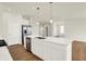Bright kitchen with white cabinets, stainless appliances, and a center island with a sink at 1615 Clover Crossing Dr # 2A, Greenfield, IN 46140