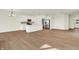 Open-concept kitchen and living room area featuring hardwood flooring and stainless appliances at 1615 Clover Crossing Dr # 2A, Greenfield, IN 46140