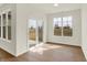 Sunlit room with large windows and sliding glass door to the backyard at 1615 Clover Crossing Dr # 2A, Greenfield, IN 46140