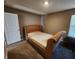 This carpeted bedroom offers a bed, a window for light, and a neutral color scheme at 1670 Crossley St, Fortville, IN 46040