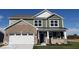 Beautiful two-story home with a modern exterior, featuring a two-car garage, stylish brick, and siding accents at 1670 Crossley St, Fortville, IN 46040