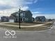 Charming two-story home with a well-manicured lawn and a sidewalk in a friendly neighborhood at 1670 Crossley St, Fortville, IN 46040