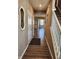 Bright hallway featuring hardwood floors and access to the upper level of the home at 1670 Crossley St, Fortville, IN 46040