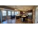 Spacious kitchen featuring stainless steel appliances, dark wood cabinets, and modern lighting fixtures at 1670 Crossley St, Fortville, IN 46040