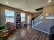 Inviting living room features wood floors, plenty of natural light, and a cozy seating area near the front entry at 1670 Crossley St, Fortville, IN 46040