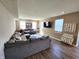 Spacious living room featuring a comfortable sofa, hardwood floors, and natural light from several windows at 1670 Crossley St, Fortville, IN 46040