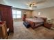 This main bedroom boasts a ceiling fan and lots of storage with multiple wood dressers at 1670 Crossley St, Fortville, IN 46040