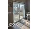 A room having sliding glass doors that provide access to the outdoor patio at 1670 Crossley St, Fortville, IN 46040