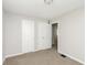 Bright bedroom with neutral carpet and paint, featuring ample closet space at 1817 Medford Ave, Indianapolis, IN 46222