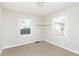 Well-lit bedroom with two windows, neutral carpet and paint at 1817 Medford Ave, Indianapolis, IN 46222