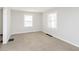 Cozy bedroom with neutral carpet and two windows at 1817 Medford Ave, Indianapolis, IN 46222