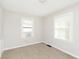 Cozy bedroom featuring neutral walls and carpet, brightened by two windows at 1817 Medford Ave, Indianapolis, IN 46222