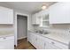 Kitchen area showcasing white cabinets, sink and stone countertops at 1817 Medford Ave, Indianapolis, IN 46222