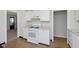 Kitchen with white cabinets and appliances, plus vinyl wood flooring at 1817 Medford Ave, Indianapolis, IN 46222