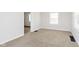 Bright living room with neutral carpet and natural light at 1817 Medford Ave, Indianapolis, IN 46222