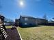 Large fenced backyard with a playset, picnic table, and the home's exterior at 1934 St James Pl, Columbus, IN 47201