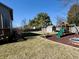 Spacious backyard featuring a playground, shed, and mature landscaping at 1934 St James Pl, Columbus, IN 47201