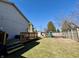 Well-maintained backyard with wooden deck, playset, and fenced perimeter at 1934 St James Pl, Columbus, IN 47201