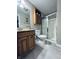Bright bathroom featuring wood cabinets, a tiled floor, and a glass-enclosed shower at 1934 St James Pl, Columbus, IN 47201