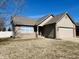 Charming single-story home featuring a brick and vinyl exterior, attached garage, and well-maintained lawn at 1934 St James Pl, Columbus, IN 47201