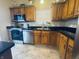 Kitchen with stainless steel appliances, tile floors, and ample cabinet space for storage at 1934 St James Pl, Columbus, IN 47201