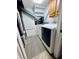 Compact laundry space with a modern washer and dryer set and cabinet storage at 1934 St James Pl, Columbus, IN 47201