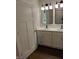 Bathroom with double sink vanity, modern lighting fixtures, and tiled shower at 1974 Ralston Ave, Indianapolis, IN 46218