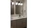 Bathroom with double sink vanity, modern lighting fixtures, and white cabinets at 1974 Ralston Ave, Indianapolis, IN 46218