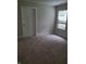 Bedroom showing a window, carpet, and door at 1974 Ralston Ave, Indianapolis, IN 46218