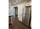 Kitchen area with stainless steel refrigerator, granite countertops and view into other rooms at 1974 Ralston Ave, Indianapolis, IN 46218