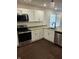 View of a modern kitchen with stainless steel appliances, granite countertops, and white cabinets at 1974 Ralston Ave, Indianapolis, IN 46218