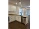 View of a modern kitchen with stainless steel appliances, granite countertops, and white cabinets at 1974 Ralston Ave, Indianapolis, IN 46218