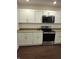 View of a modern kitchen with stainless steel appliances, granite countertops, and white cabinets at 1974 Ralston Ave, Indianapolis, IN 46218