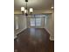 Spacious living room featuring hardwood floors, modern light fixtures, and bright natural light at 1974 Ralston Ave, Indianapolis, IN 46218