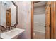 Bathroom with pedestal sink, decorative mirror, tile floor, and access to the shower/tub at 2163 Laurel Leaf Ln, Avon, IN 46123