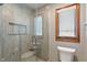 Tiled bathroom offers a glass shower, storage niche, and a wood framed window for natural light at 2163 Laurel Leaf Ln, Avon, IN 46123