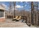 Relax on this home's wooden deck featuring two lounge chairs and a beautiful wooded view at 2163 Laurel Leaf Ln, Avon, IN 46123