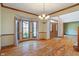 Elegant dining area with hardwood floors, chandelier, and bay window overlooking the lawn at 2163 Laurel Leaf Ln, Avon, IN 46123