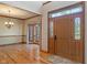 Grand foyer with hardwood floors, decorative chandelier, and view into bay window dining area at 2163 Laurel Leaf Ln, Avon, IN 46123