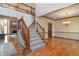 Open foyer featuring a staircase, hardwood floors, and a glimpse of a cozy living area at 2163 Laurel Leaf Ln, Avon, IN 46123