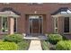 Inviting front entrance with brick facade, manicured bushes and glass paneled door at 2163 Laurel Leaf Ln, Avon, IN 46123