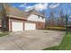 Attached multi-car garage featuring a wide driveway and exterior basketball hoop at 2163 Laurel Leaf Ln, Avon, IN 46123
