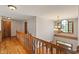 Upstairs hallway with hardwood floors, wooden banister, and decorative chandelier at 2163 Laurel Leaf Ln, Avon, IN 46123