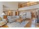 Spacious living room with hardwood floors, large windows, and a view of the second-story landing at 2163 Laurel Leaf Ln, Avon, IN 46123