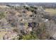 Community aerial shot showcasing homes nestled among trees, with city buildings visible in the distance at 2215 Van Ness Pl, Indianapolis, IN 46240