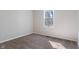 Empty bedroom featuring a bright window and soft carpeted flooring at 2215 Van Ness Pl, Indianapolis, IN 46240