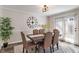 Elegant dining room with a modern light fixture and sliding glass doors at 2215 Van Ness Pl, Indianapolis, IN 46240
