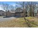 Charming home exterior featuring a large driveway and attached garage at 2215 Van Ness Pl, Indianapolis, IN 46240